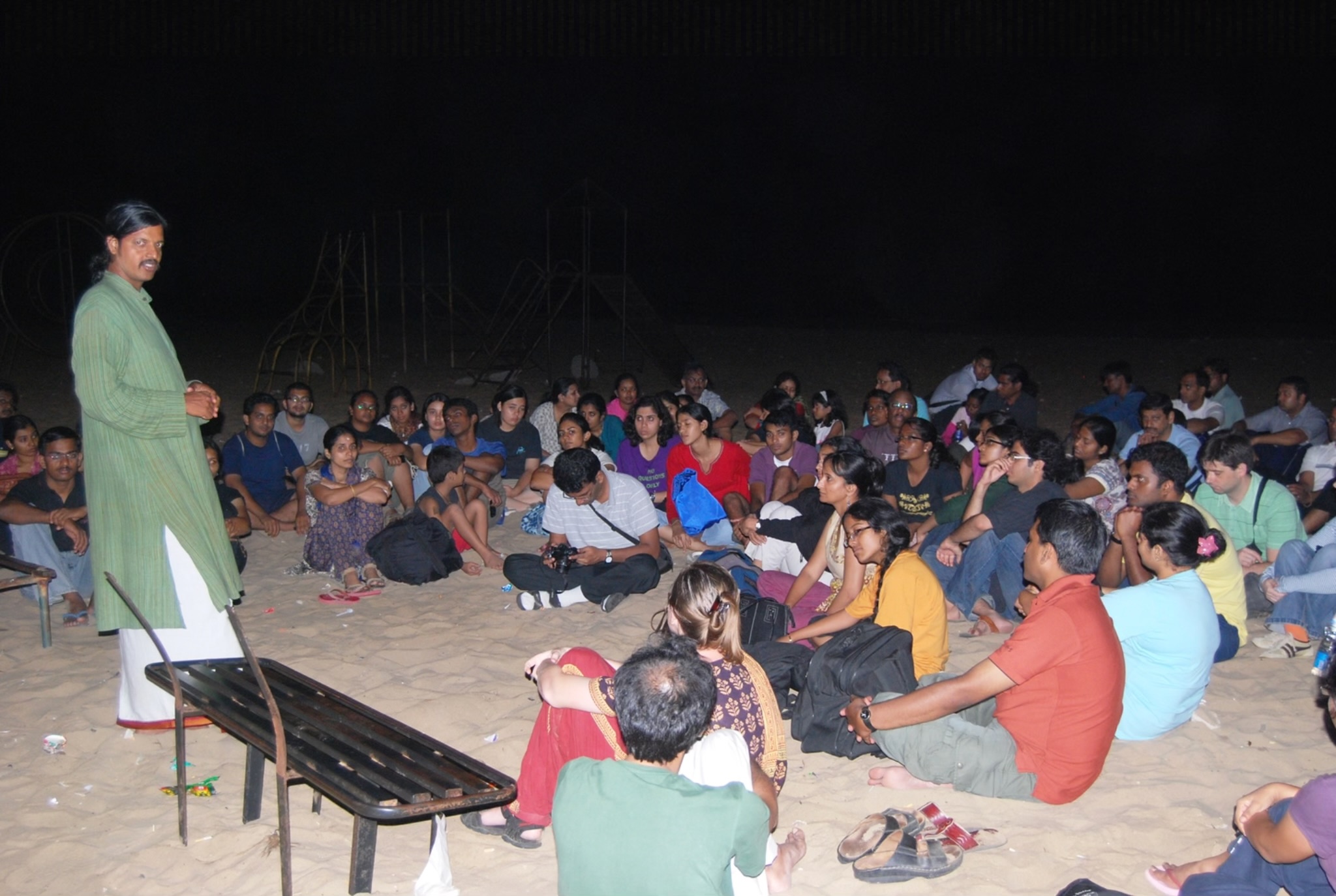 Arun V. explains the night's work to students gathered on the beach