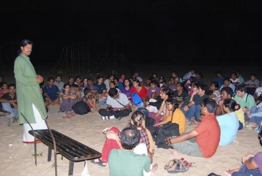 Arun V. explains the night's work to students gathered on the beach
